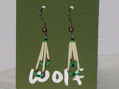Two short quills and the two long quills all connected with Black and Green size thirteen cut glass beads. Ear attachment is French Hooks